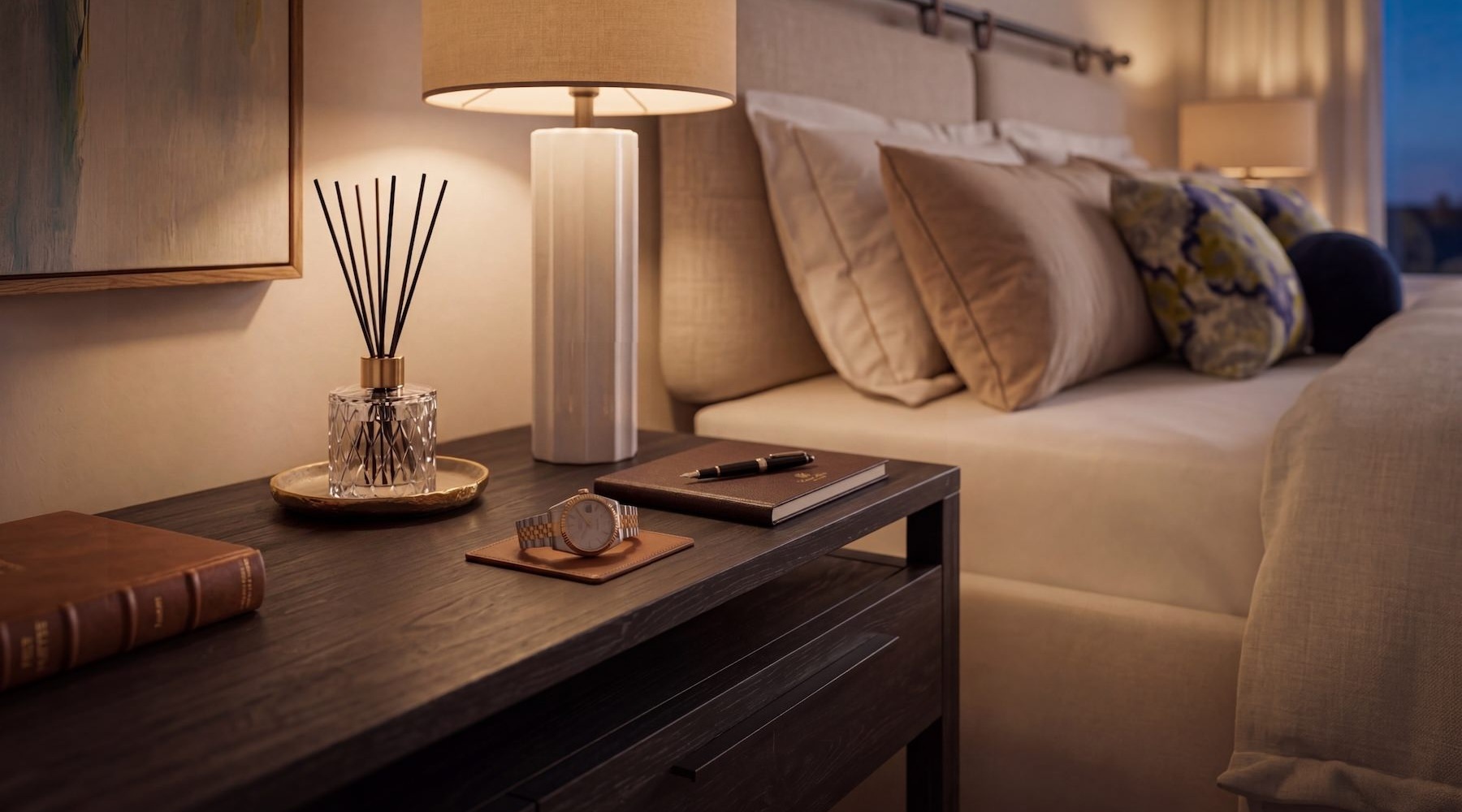 a bedroom with a bed and a nightstand with a lamp