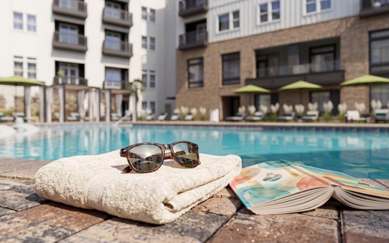 a pool with a towel and sunglasses on it