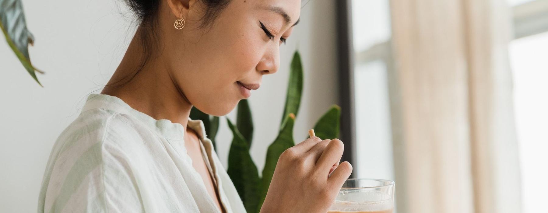 a woman holding a drink